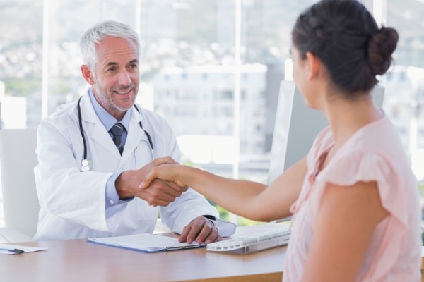 Doctor shaking hands to patient