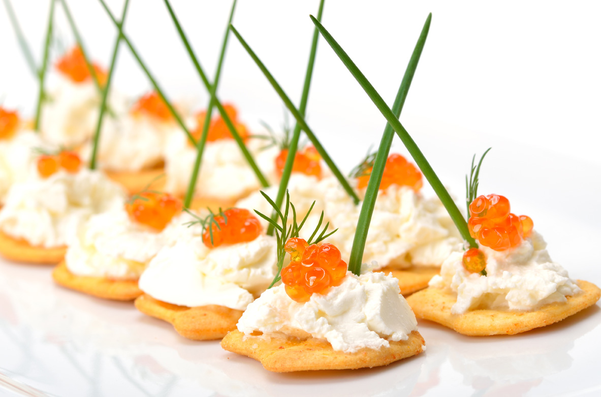 Crackers with cream cheese and red caviar