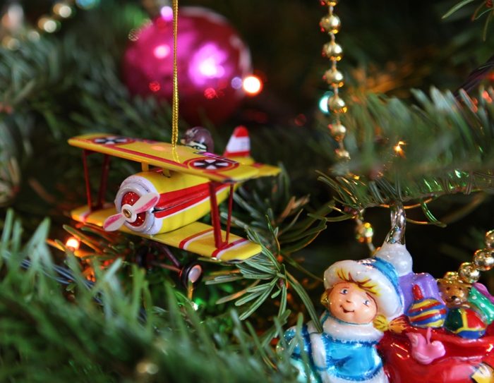 Colgar una miniatura de deseo acariciado en el árbol de Navidad