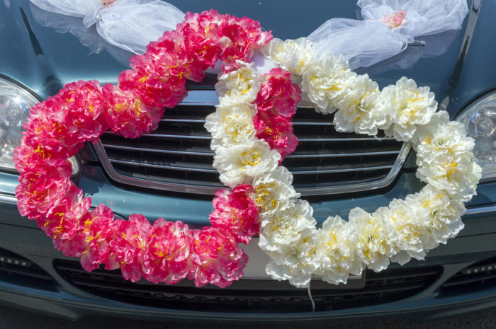 Wedding car decoration in the form of hearts from flowers