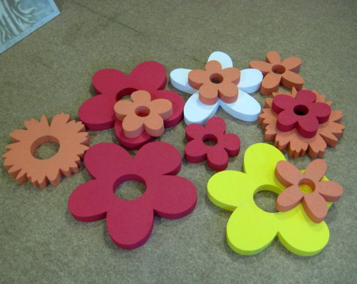 flowers from the ceiling tiles of different sizes and colors on the floor