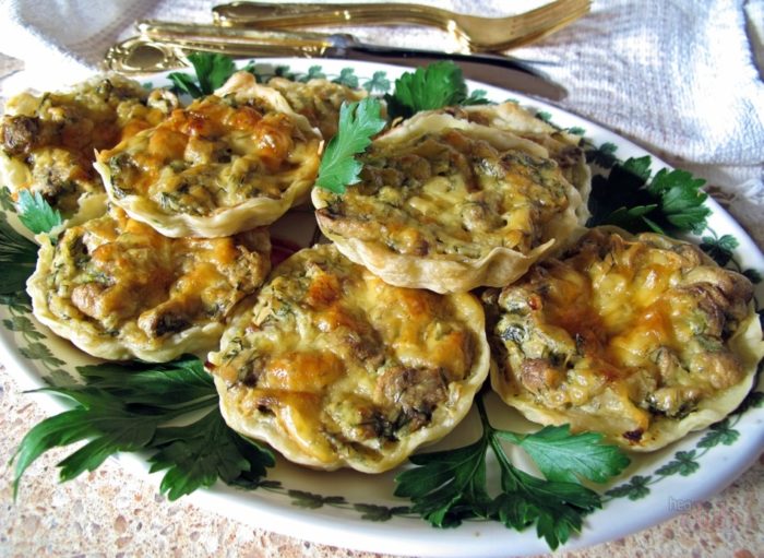 ароматная праздничная закуска с грибами сложена на блюде перед подачей к столу