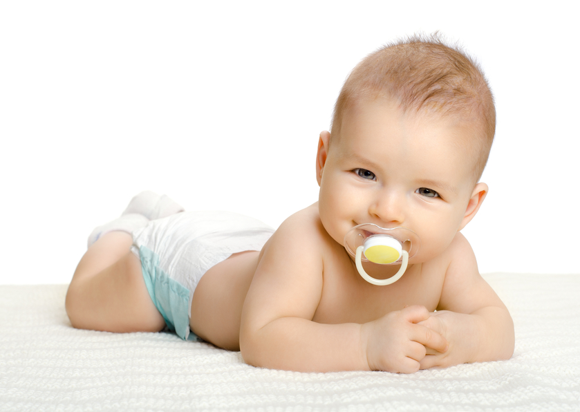 the very  beautiful  little baby , lie on stomach,  on white background, isolated