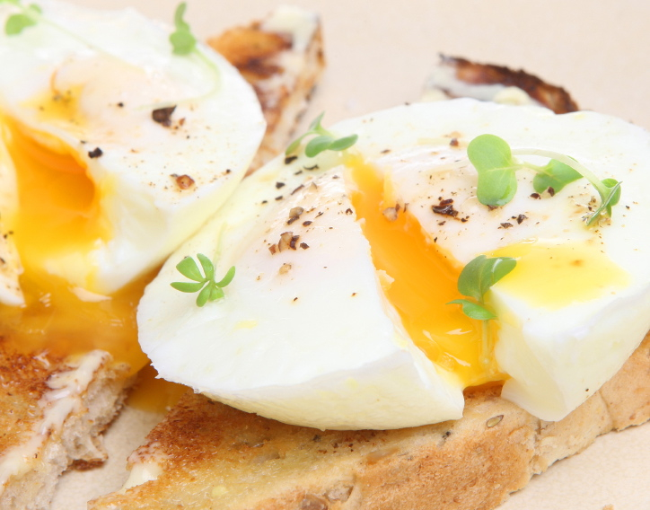 Perfectly poached fresh eggs on warm buttered toast.